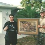2008 Grand prize winner Loretta Castonguag receives her “ Florida Treasures” painting from Bill Samuels of the Florida Panther Project.